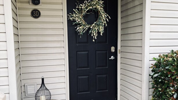 A black door with a wreath, a doormat with "hello" text, a lantern, and a mailbox with the number "3D". - Off Season Rates!  Ideal location on Lake Hamilton! (Lake Hamilton)