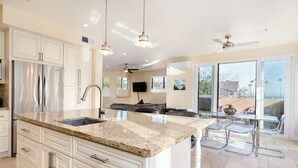 A modern kitchen with granite countertops, stainless steel appliances, and a large island. - Luxurious Ocean 4bd/3ba Oceanview Villa (Santa Cruz)