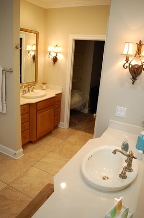 Een bad/douchecombinatie, een haardroger, handdoeken, zeep