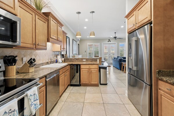 A modern kitchen with wooden cabinets, stainless steel appliances, and a central island.