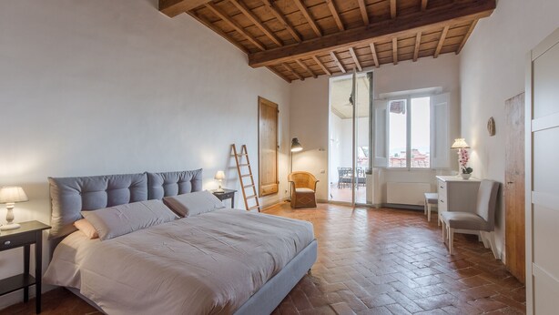 A bedroom with a bed, a nightstand, a chair, a desk, and a window. - Welcome to G-HOUSE in FLORENCE  (Firenze)
