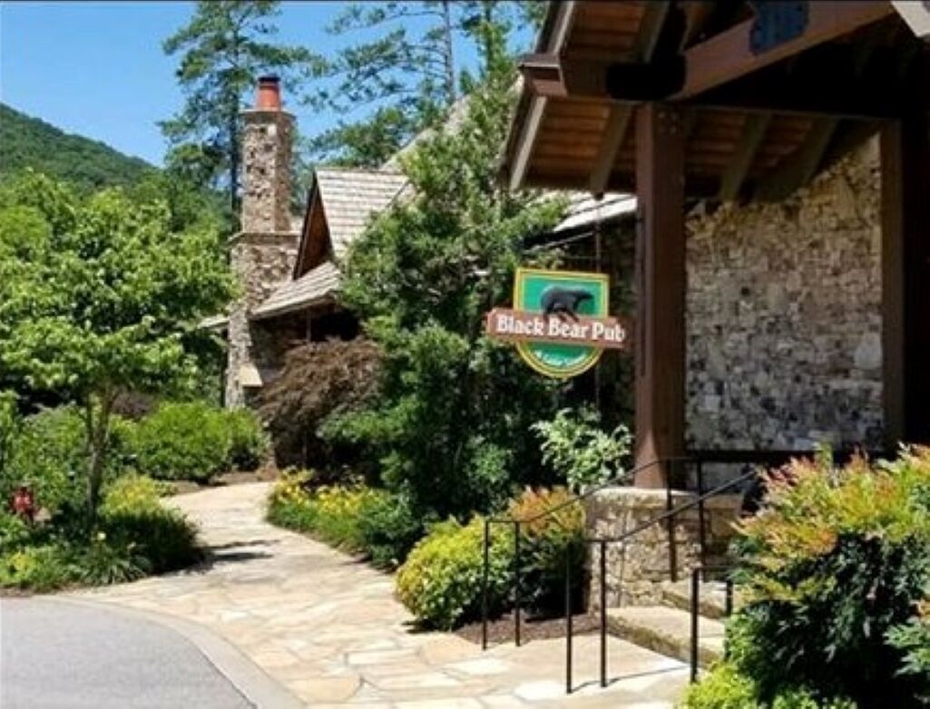 A stone building with a sign for Black Bear Pub.