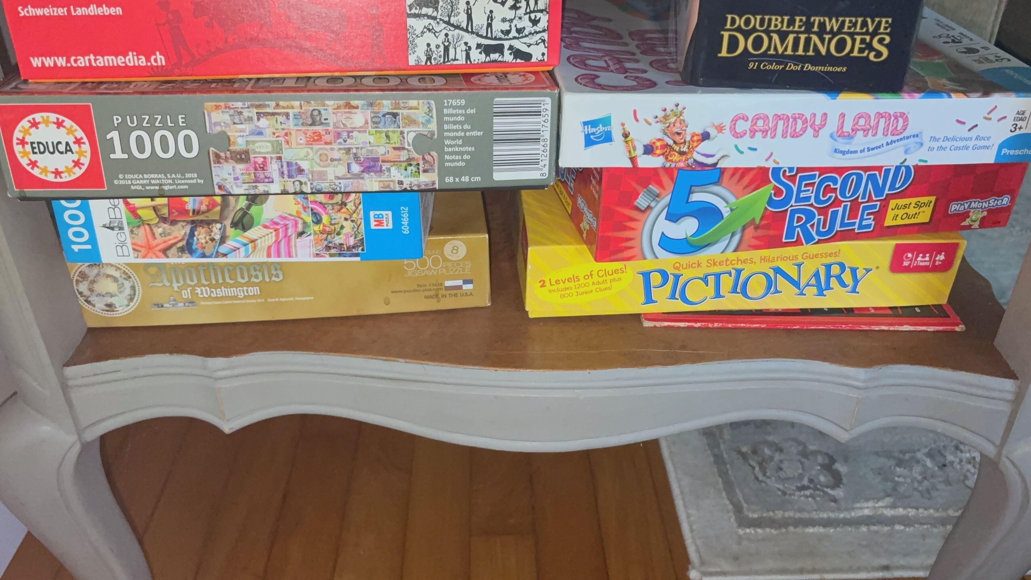 A variety of board games on a wooden table.