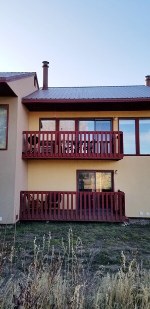 A two-story building with a balcony and a chimney.