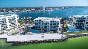 A coastal hotel with multiple floors, a swimming pool, and a marina with boats. - Incred Panoramic Gulf View - Sunsets, Water, Private Beach,E Pass Area, Boatslip (Destin)