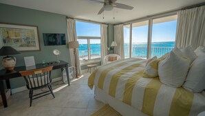 A bedroom with a bed, desk, chair, and a view of the ocean. - Incred Panoramic Gulf View - Sunsets, Water, Private Beach,E Pass Area, Boatslip (Destin)
