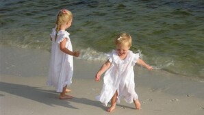 Two children in white dresses walking on a sandy beach with waves in the background. - Incred Panoramic Gulf View - Sunsets, Water, Private Beach,E Pass Area, Boatslip (Destin)