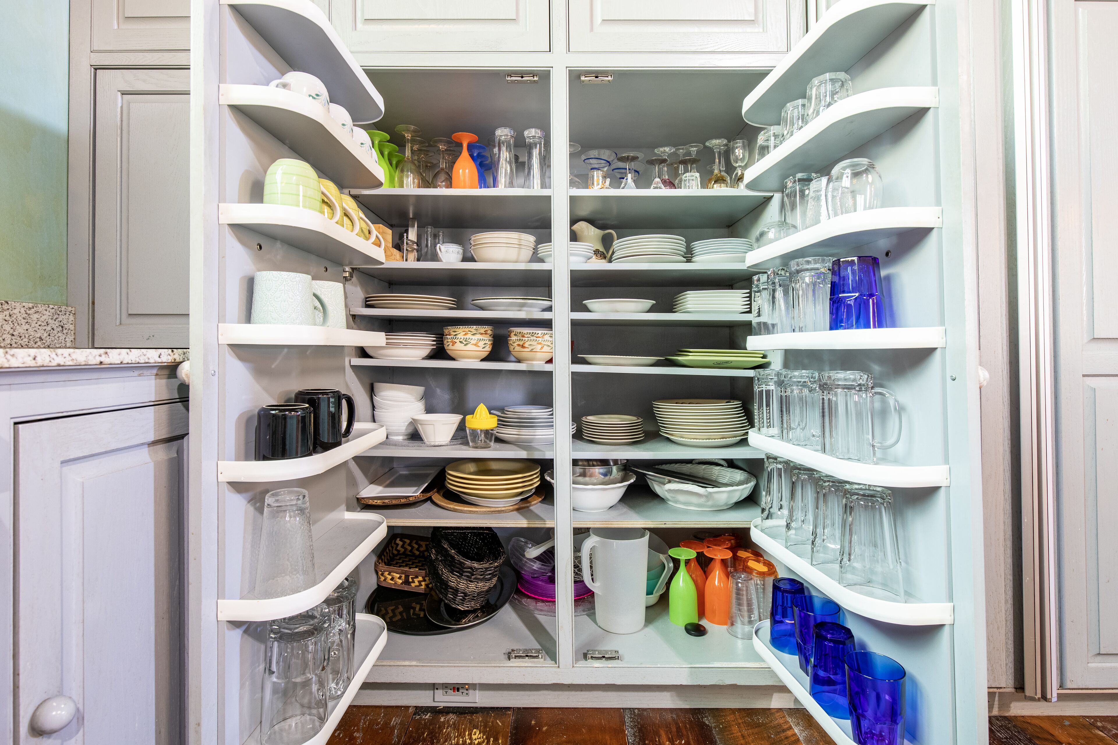 Kitchen is well stocked with dishes, glassware, pots, pans and other essentials