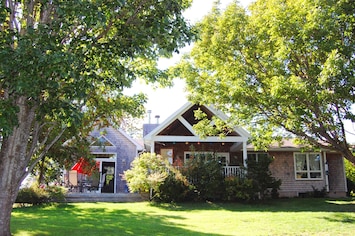 The side view of house with ample decks and seating areas.