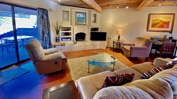 A cozy living room with a fireplace, TV, and comfortable seating. - Charming Tubac Villa located within Tubac Golf Resort (Tubac)