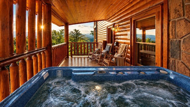 A hot tub on a wooden deck with chairs and a view of mountains. - A+ Views & Location! Minutes 2 Dollywood. Hot Tub Games Pet Friendly Resort Pool (Pigeon Forge)
