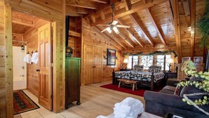 A log cabin interior with a bedroom, bathroom, and a dining area. - A+ Views & Location! Minutes 2 Dollywood. Hot Tub Games Pet Friendly Resort Pool (Pigeon Forge)