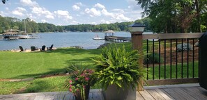 A deck with a view of a lake, dock, and boats. - Lake Front Getaway, Family Friendly. (Mooresville)