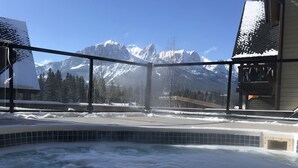 A hot tub with a view of snow-covered mountains. - Premium penthouse in the heart of the Canadian Rockies! Walk to busy downtown. (Canmore)