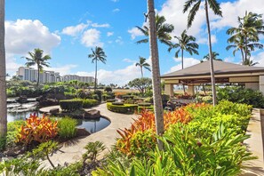 A resort with a pool, palm trees, and a gazebo. - Ko Olina Luxury beachfront condo next to Disney Aulani and Marriott's Beach Club (Kapolei)