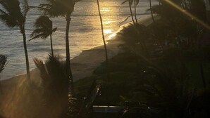 A beach with palm trees and a sunset. - On the beach, Beautiful ocean views. (Kihei)
