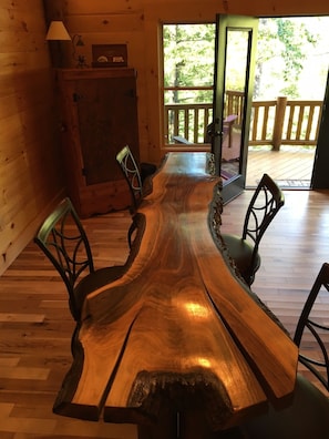 Enjoy meals in this dining area with a long, uniquely shaped table and comfortable chairs.