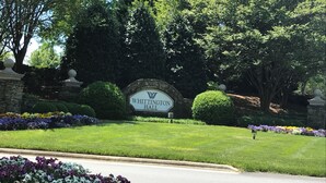 A sign for Whittington Hall surrounded by well-maintained lawns and flower beds. - Lovely Home, Perfect location, Coliseum, Golf, HPU, Back Porch & Community pool (Jamestown)