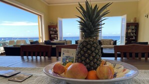 A dining table with a plate of fruit and a map. - Private Gated Ocean Front Villa Pool&Tide Pool Cane Bay Beach Wifi Wedding Venue (Christiansted)