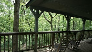 A wooden deck with a railing, surrounded by trees. - Private, Secluded, Relaxing Cabin.   1853
Ask about out WEDDING OPPORTUNITIES (Blairsville)