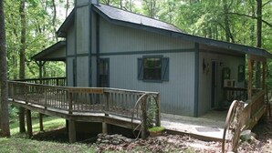 A rustic cabin with a wooden deck and a wheelbarrow. - Private, Secluded, Relaxing Cabin.   1853
Ask about out WEDDING OPPORTUNITIES (Blairsville)