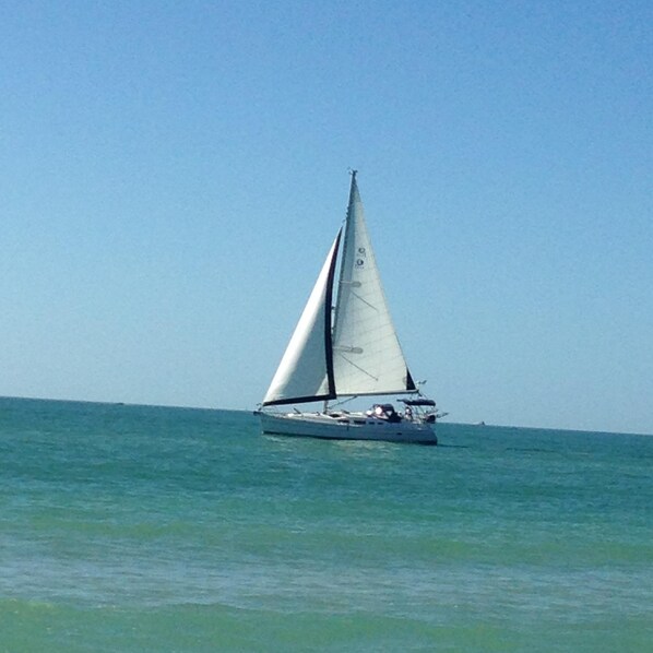A sailboat on calm waters. - DIRECTLY ON BEACH - ST PETE BEACH PASS-A-GRILLE - Awesome Sunsets from Balcony (St Pete Beach)