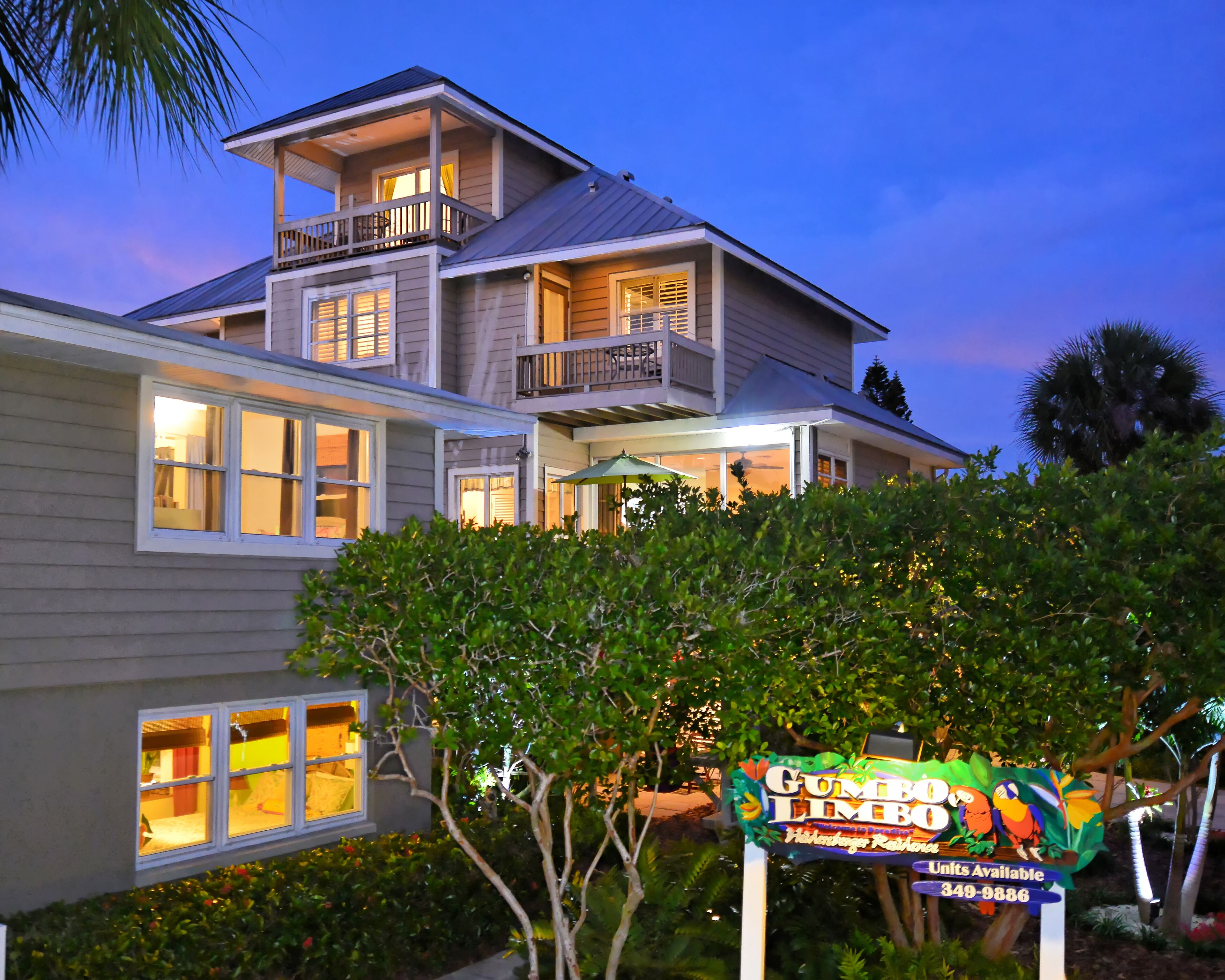 A two-story house with a balcony, a sign for 'Gumbo Limbo', and a number of windows.