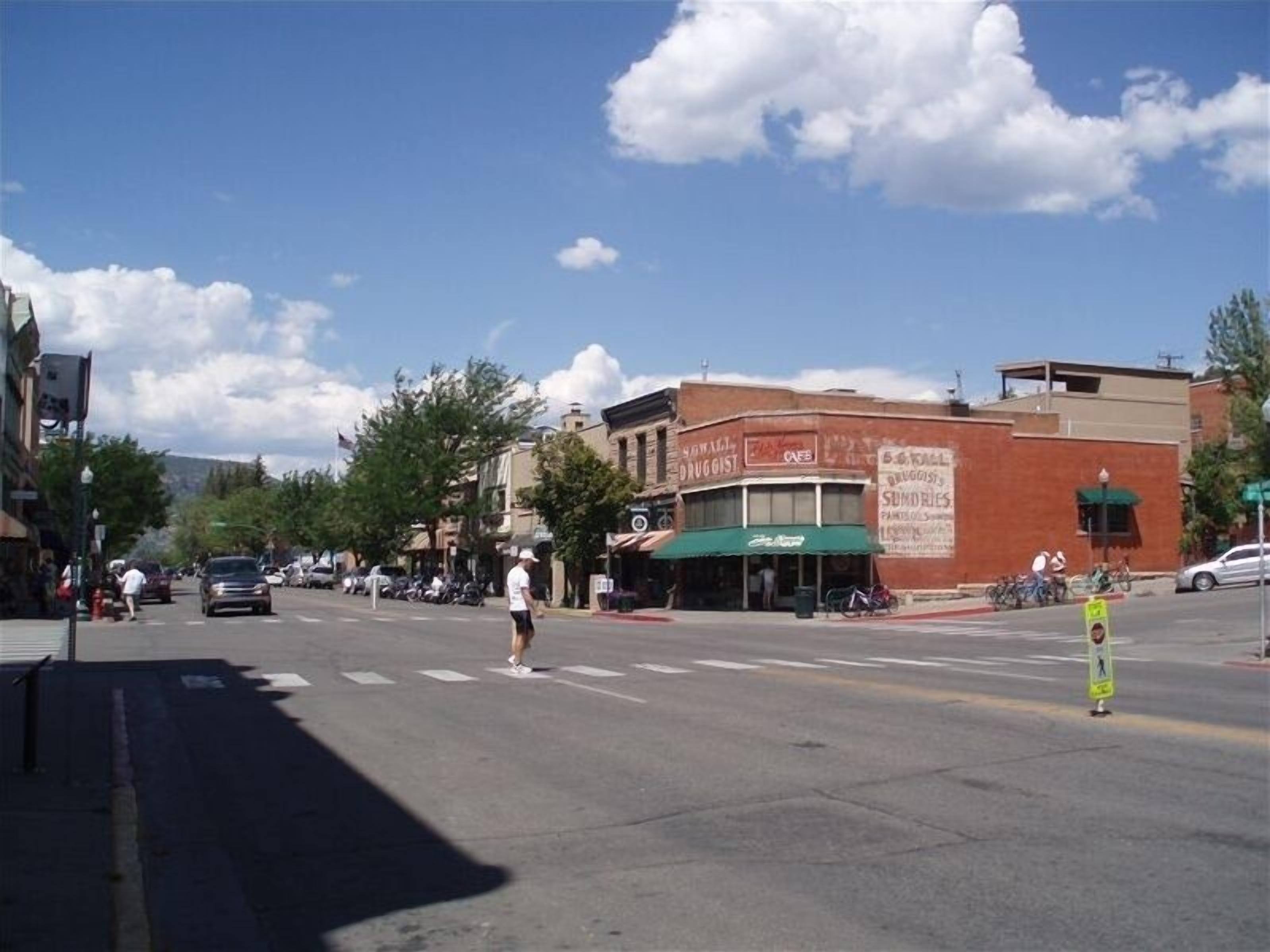 A street view with buildings, a crosswalk, and a clear sky.