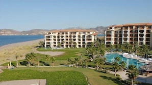 A resort with multiple buildings, a large pool area, and a beach view. - Paraiso Del Mar - La Paz Oceanfront 3 Bedroom (La Paz)