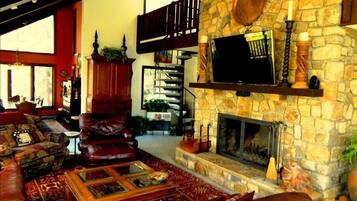 Televisión, chimenea, reproductor de DVD, biblioteca de música