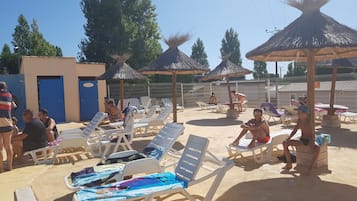 Seasonal outdoor pool, open 9 AM to 7 PM, pool umbrellas, pool loungers