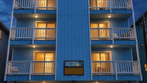 A multi-story hotel with balconies, large windows, and a central sign. - “BEACHFRONT ELM” IS CALLING
~Oceanfront~Private Beach Access~Pool~ (Carolina Beach)
