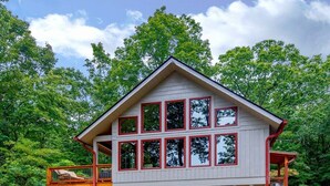 A two-story building with multiple windows and a covered deck area. - Sweet Refrain in Pisgah Forest with VIEW (PIsgah Forest)