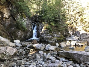 A waterfall surrounded by rocks and trees. - Beautiful Off-the-Grid Cabin. Next to A.T. in Andover Notch. (Andover West Surplus)