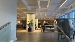 A modern interior with a staircase, a dining area, and a reception desk. - Between Lowe's and Ritz Carlton Hotels Beachfront on Lincoln (Miami)