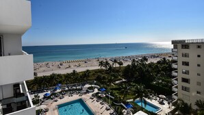 A hotel with a pool, beach view, and palm trees. - Between Lowe's and Ritz Carlton Hotels Beachfront on Lincoln (Miami)