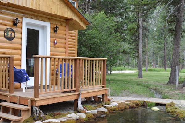 Front door with porch and creek