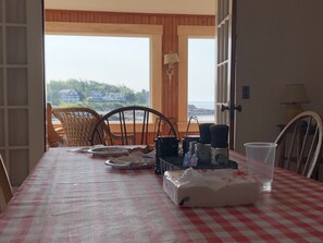 Enjoy meals in this cozy dining area with a view of the surrounding coastal landscape.