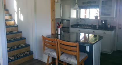 Tranquil setting surrounded by panoramic mountain views, grazing horses