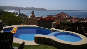 A swimming pool with a view of the ocean and hills in the background. - Best Location in Sayulita.Stunning Ocean Views. 2 min walk to beach (Sayulita)