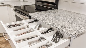 A kitchen drawer with utensils neatly organized.