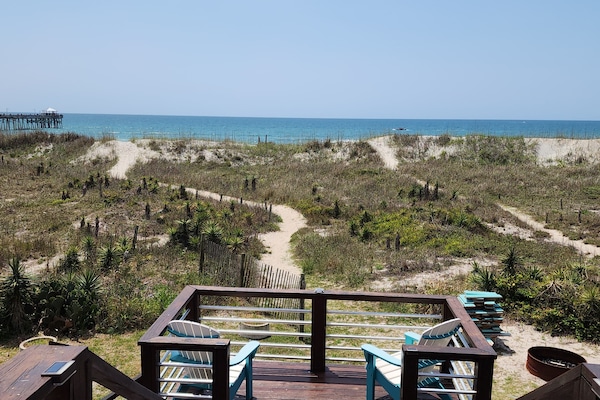 Steps downstairs to head to the beach with separate deck area.