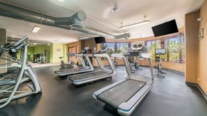 A gym with treadmills, exercise bikes, and a rowing machine.