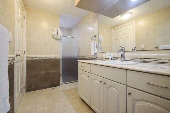 A bathroom with a sink, mirror, and towel rack.
