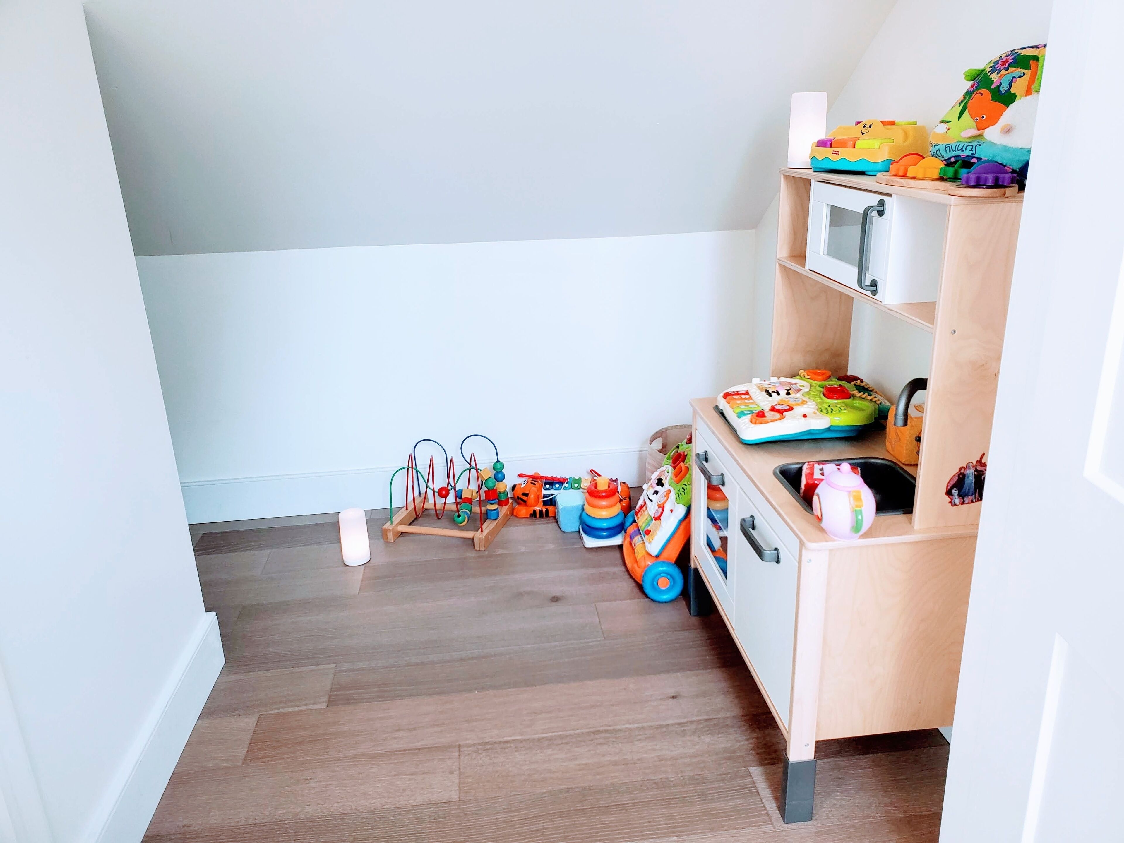 A child's play area with toys and a wooden cabinet.