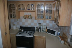 Fridge, microwave, stovetop, coffee/tea maker