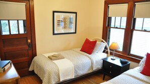 A bedroom with a bed, bedside table, lamp, and a framed picture on the wall. - Fantastic duplex in the Historic District (Minneapolis)