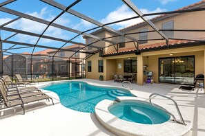A pool area with lounge chairs, a hot tub, and a covered patio. - 6 Bedroom Disney Villa - Private Pool & Spa - Central Kissimmee (kissimmee)