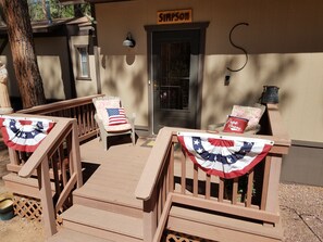 Relax on the Simpson deck with two lounge chairs, surrounded by a lattice fence.