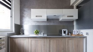 A modern kitchen with wooden cabinets, a stainless steel sink, and a microwave. - Charming Modern cosy Cottage -50m2- (Bourbourg)